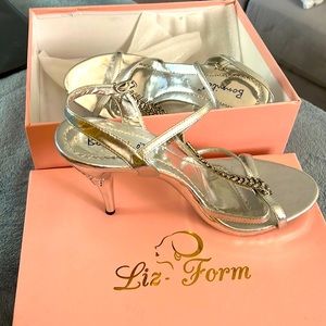 Silver stiletto heels with a diamond accent
